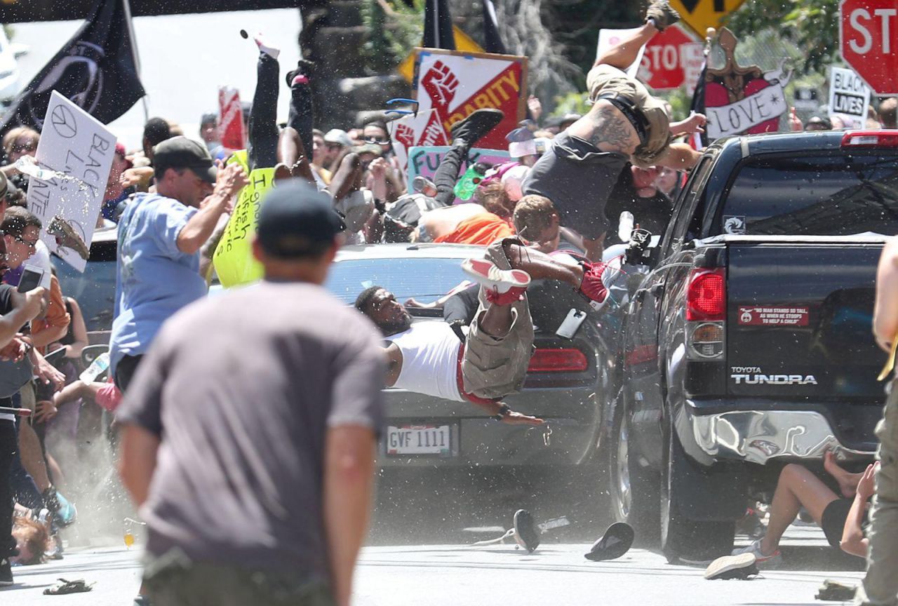 La gente sale volando cuando un auto se estrella contra un grupo de manifestantes que se concentran en contra de un mitin de Unite the Right en Charlottesville, Virginia, EE. UU.
