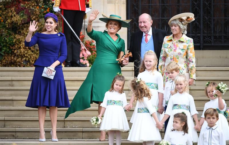 La duquesa Sarah de York (2i) y su hija Beatrice de York (i) saludan junto a George Brooksbank (2d), padre de Jack Brooksbak, tras el enlace.