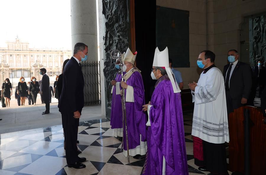 Felipe VI saluda al cardenal Carlos Osoro, que preside la eucaristía.