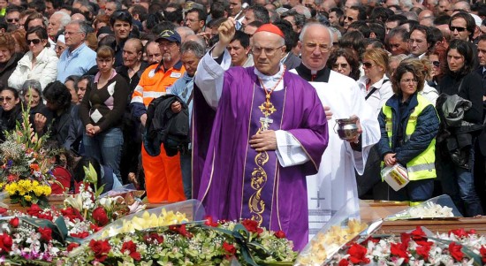El secretario de Estado del Vaticano, Tarsicio Bertone, bendice los féretros de las vícticas del terremoto (EFE)