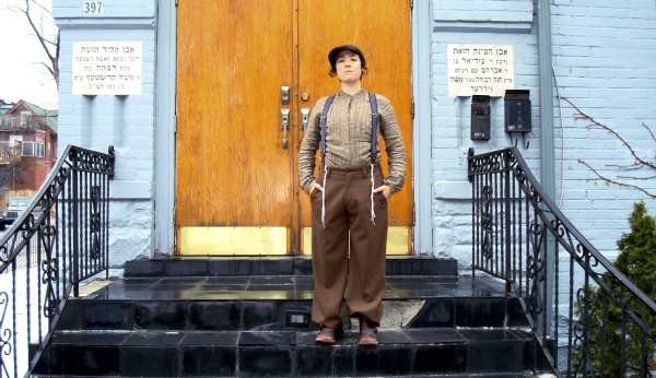 La artista judía ortodoxa lesbiana Zohar (nombre ficticio) se fotografía a sí misma ante una sinagoga, ataviada con el tradicional traje del varón judío en la primera mitad del siglo XX. (Efe)